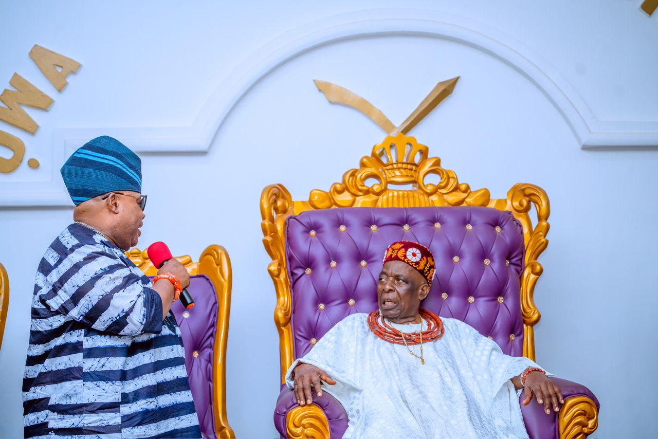 Oba Aromolaran II seated on the palace throne while receiving a visitor